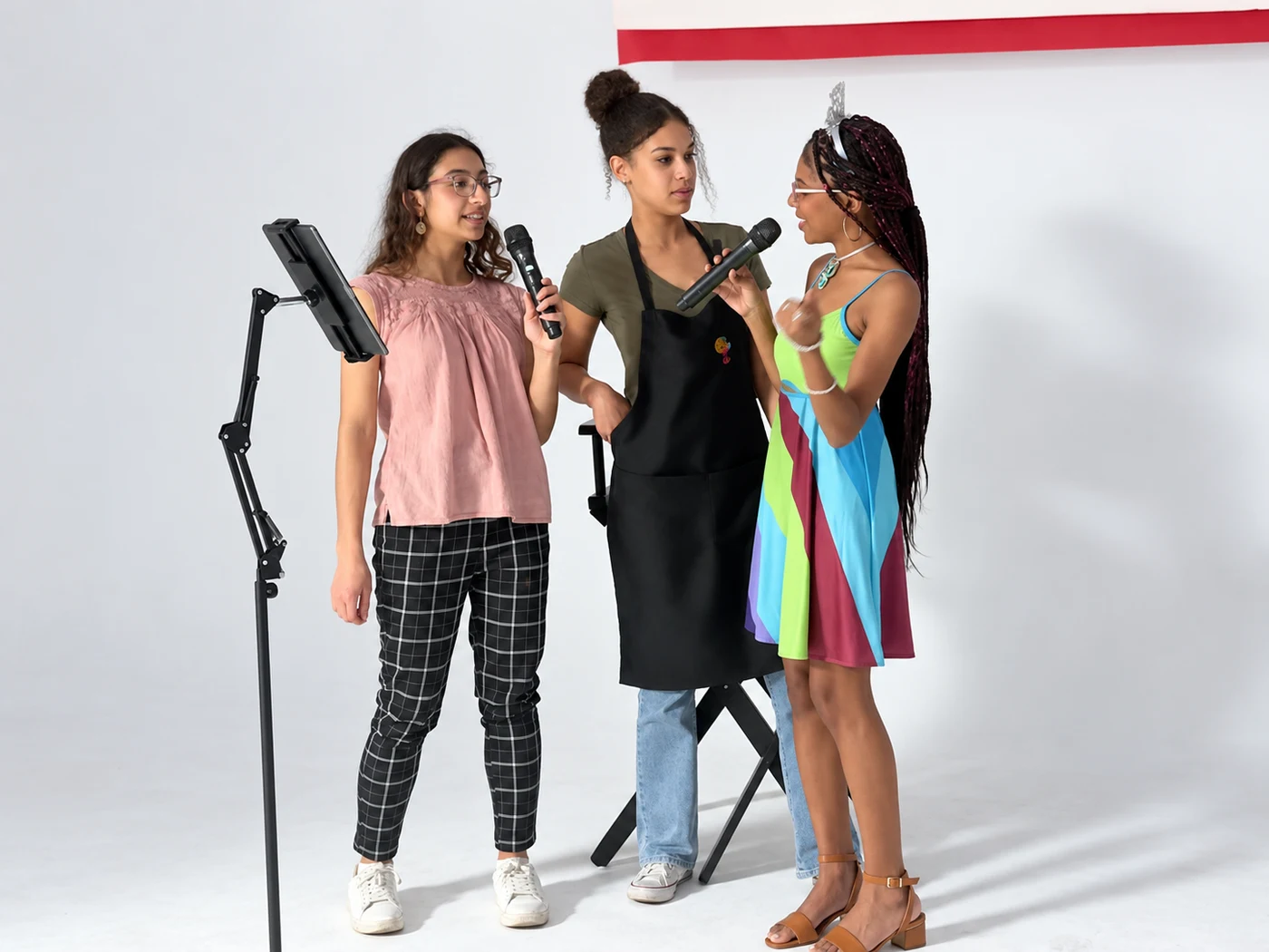 Three Studio 786 guests singing together at the white cyc-wall space