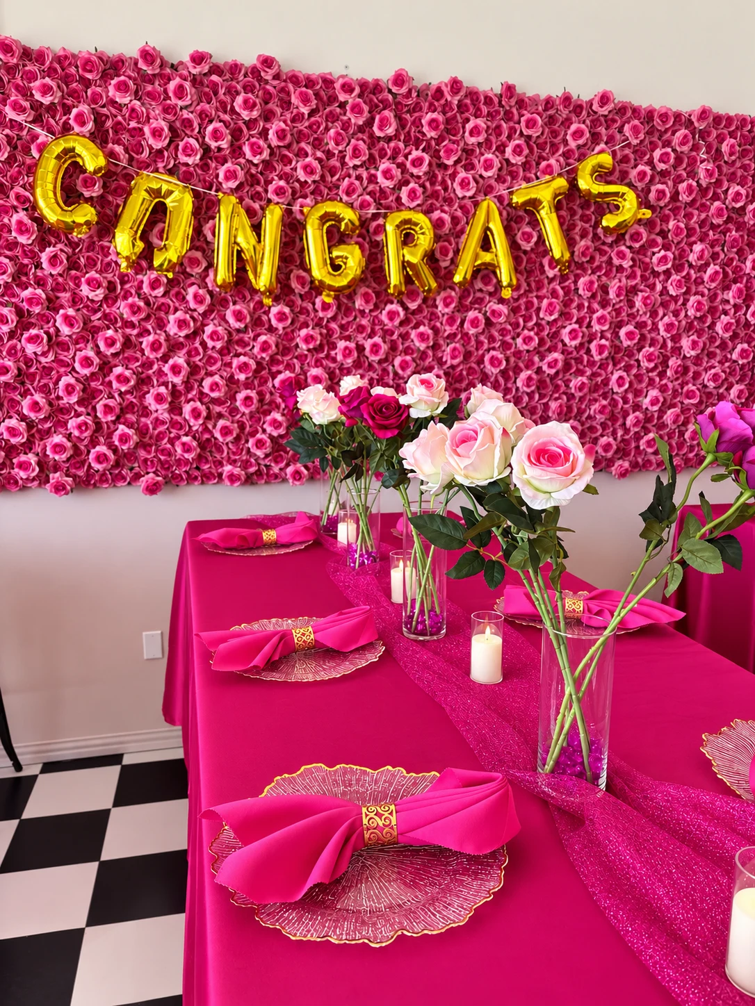 Pink table setting and original rose-wall backdrop at Studio 786