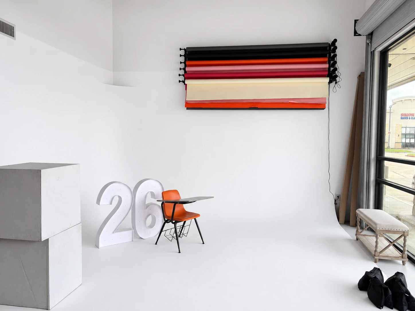 Studio 786 white cyclorama photo studio with backdrop rolls, props and a storefront window