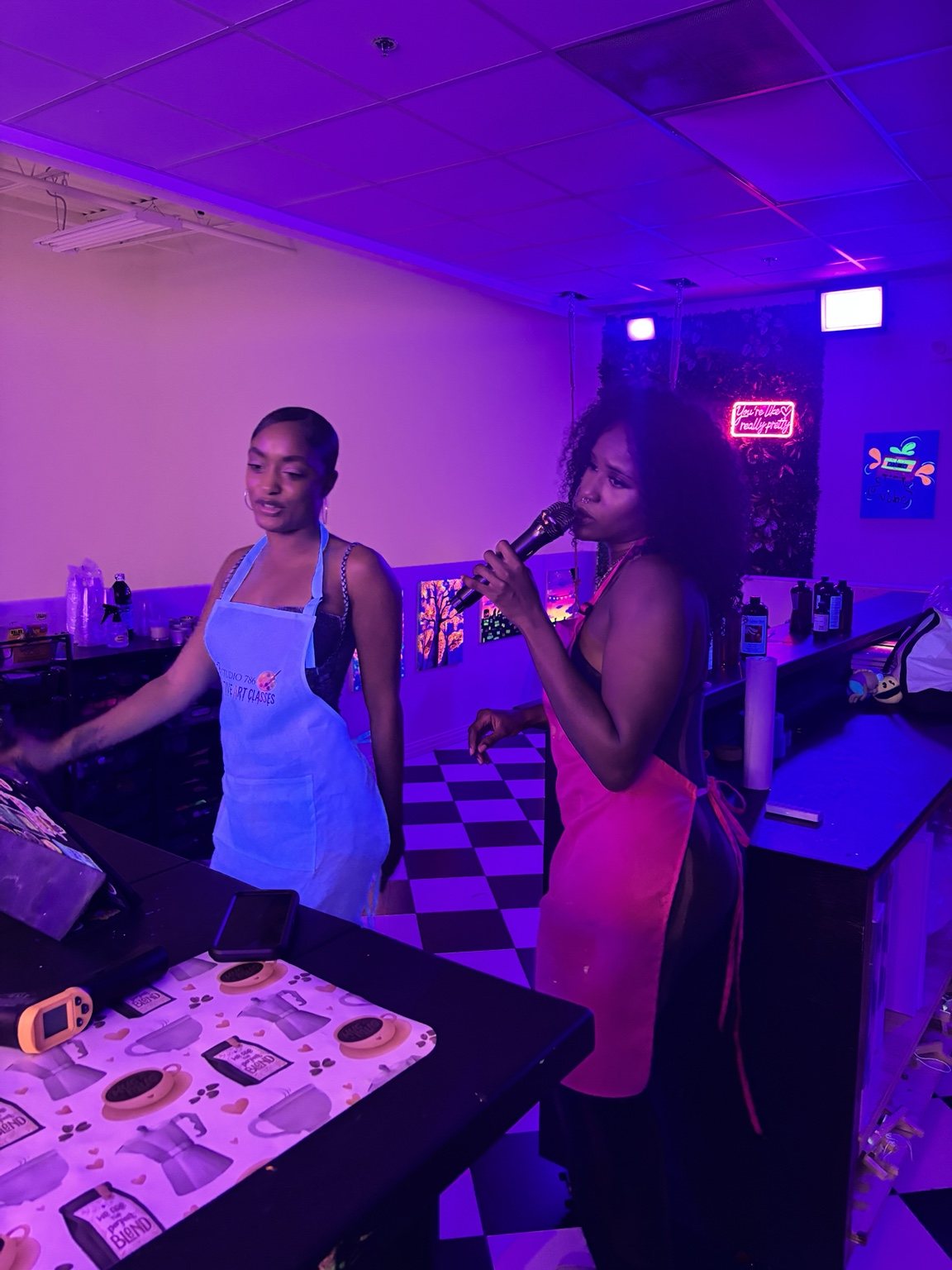 Friends singing karaoke together during a Studio 786 candle-making night in Houston