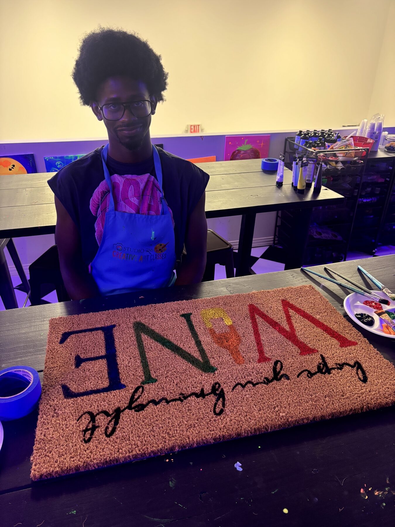 Guest creating a colorful home doormat during a Studio 786 art class