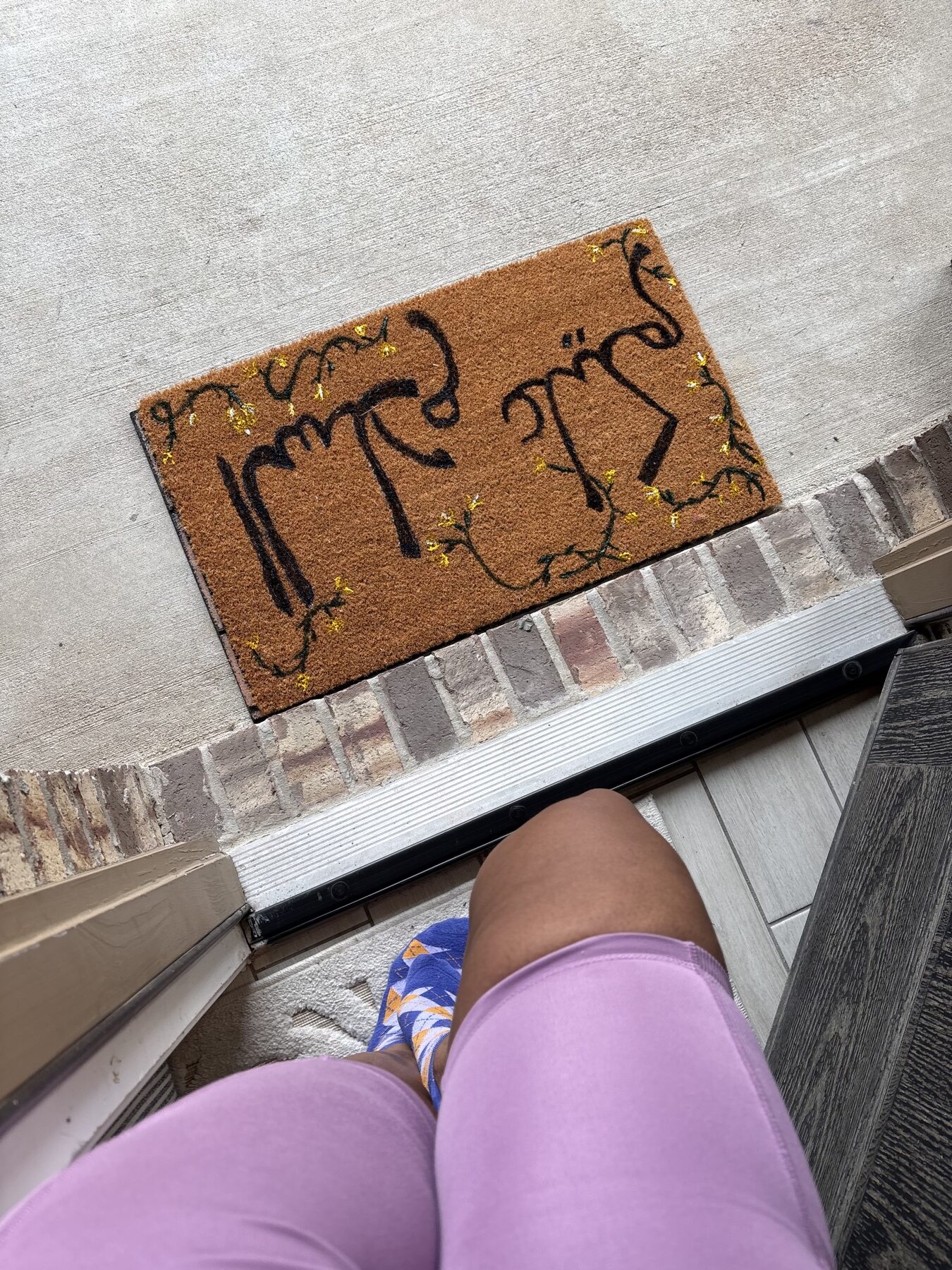 Finished custom painted doormat displayed at a guest’s front door