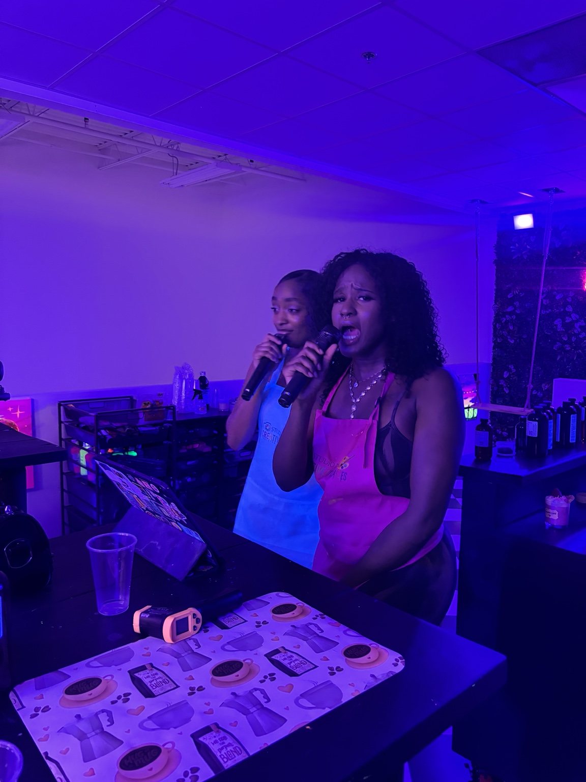Guests enjoying karaoke while making custom candles at Studio 786 Houston
