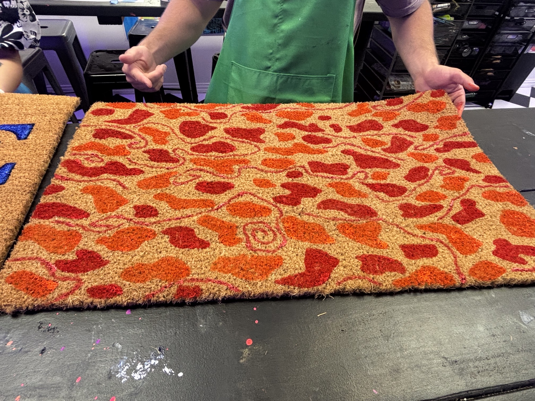 Close-up of a colorful pizza design painted doormat created in Houston